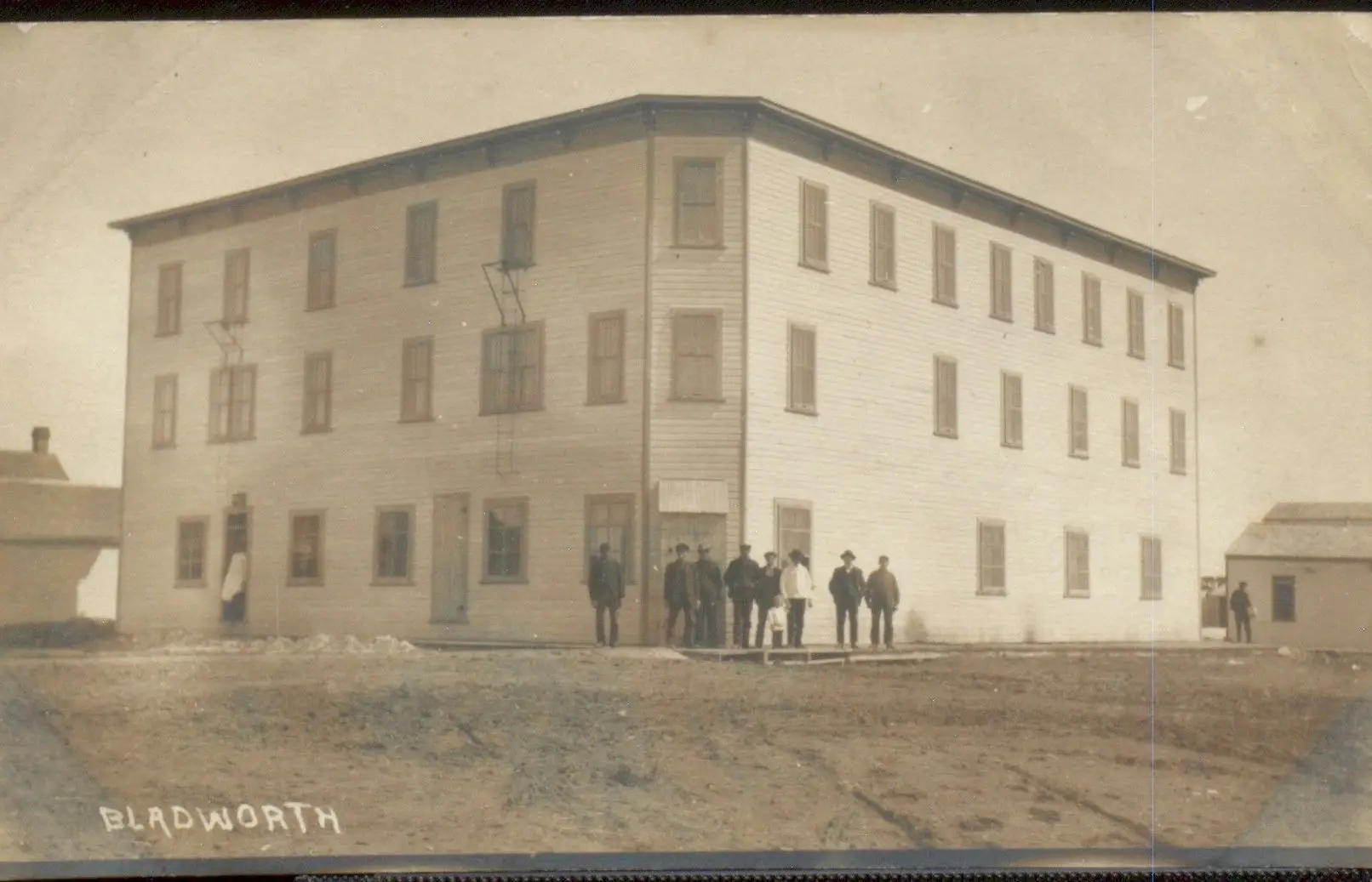 Large three-storey building with townsmen out front